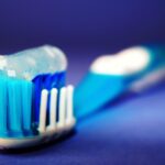 closeup and selective focus photography of toothbrush with toothpaste
